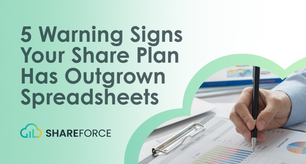 A hand in a blue shirt holds a pen, writing on a financial report with charts and data.